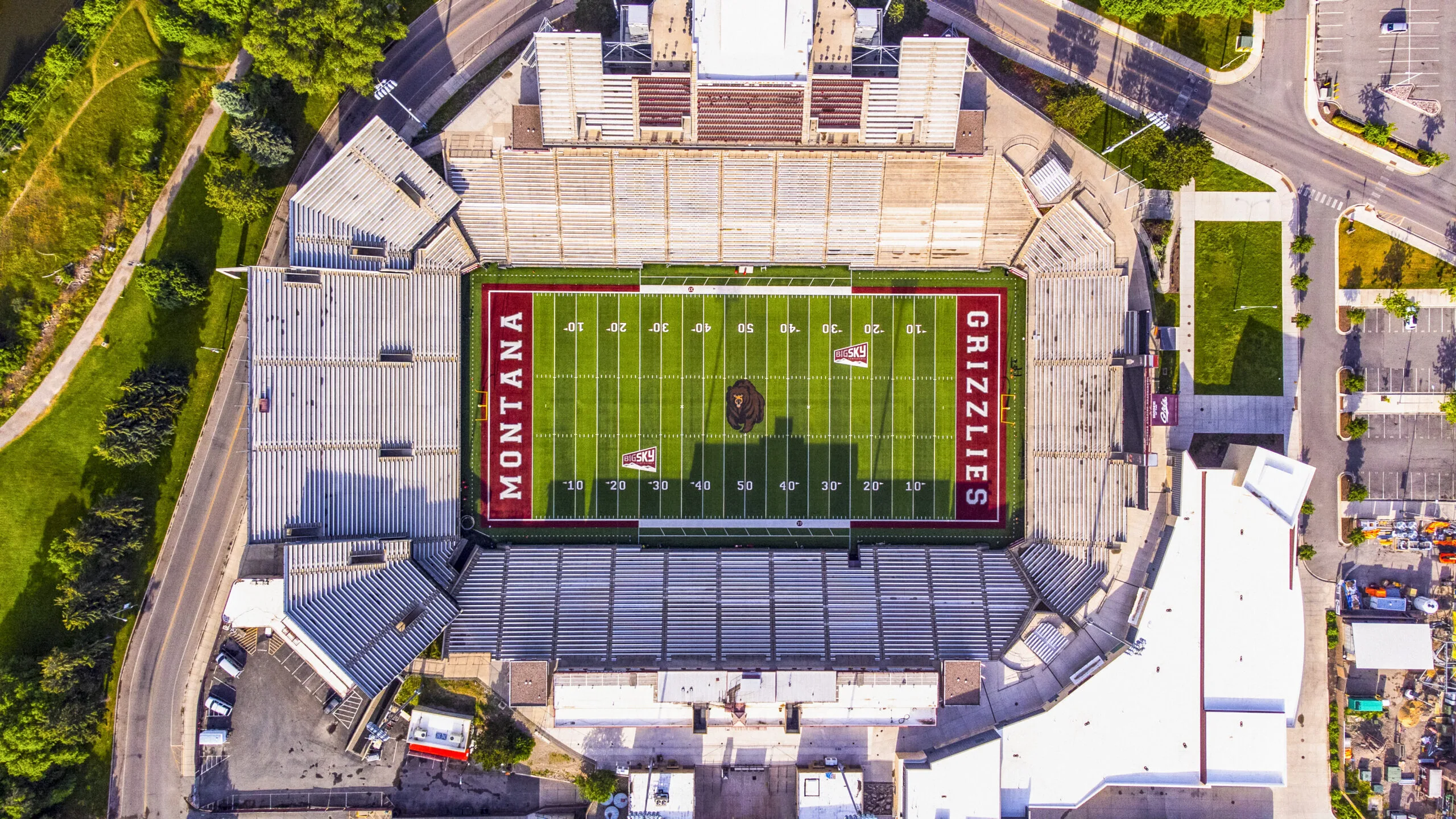 Aerial view of a football stadium with a green field and maroon end zones.